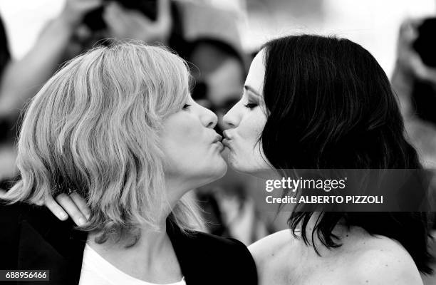 French actress Emmanuelle Seigner and French actress Eva Green kiss on May 27, 2017 during a photocall for the film 'Based on a True Story' at the...