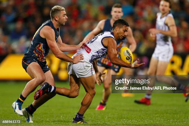 Rory Atkins of the Crows tackles Danyle Pearce of the Dockers during the 2017 AFL round 10 match between the Adelaide Crows and the Fremantle Dockers...