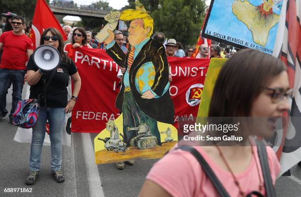 Leftist demonstrators, including one carrying a coardboard effigy of U.S. President Donald Trump, march to protest the G7 summit at nearby Taormina...
