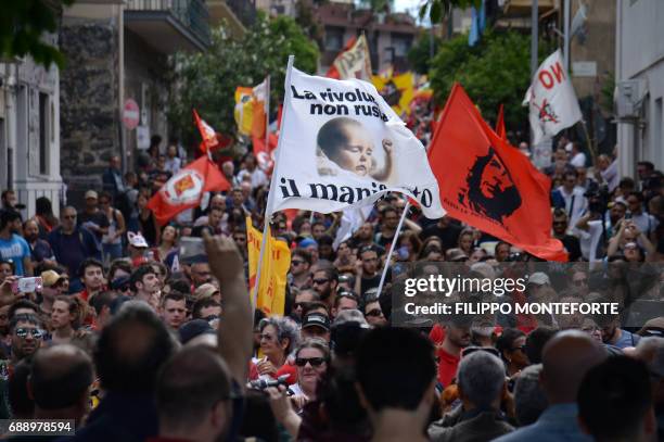 People march during a rally against the G7 Summit in Giardini-Naxos near the venue of the G7 summit of Heads of State and of Government in Taormina,...