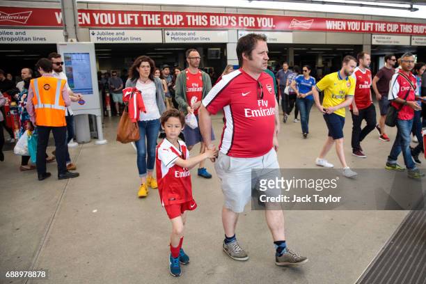 Football fans arrive at Wembley Park Tube Station ahead of the FA Cup final on May 27, 2017 in London, England. Football fans will watch Arsenal play...