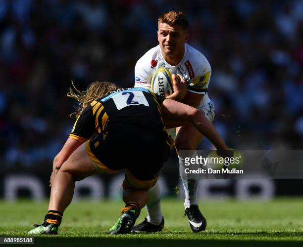 Henry Slade of Exeter Chiefs is tackled by Tommy Taylor of Wasps during the Aviva Premiership Final between Wasps and Exeter Chiefs at Twickenham...