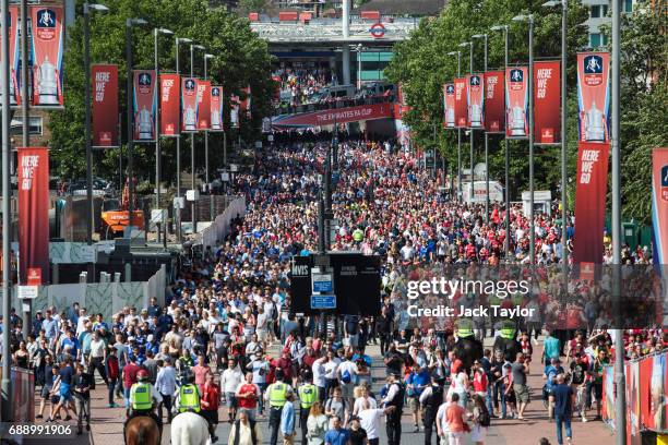 Football fans make their way to Wembley Stadium ahead of the FA Cup final on May 27, 2017 in London, England. Football fans will watch Arsenal play...