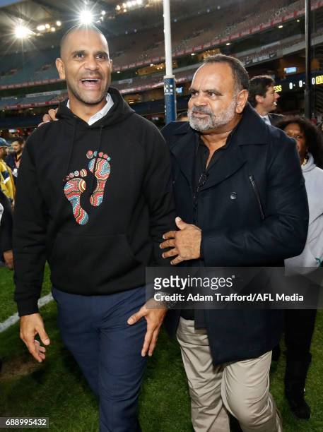 Michael O'Loughlin and Michael Long wave to the crowd during the Long Walk before the 2017 AFL round 10 Dreamtime at the G match between the Richmond...