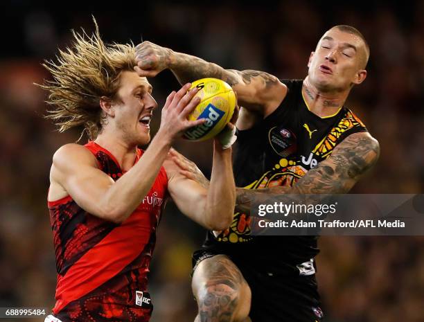 Dyson Heppell of the Bombers marks the ball ahead of Dustin Martin of the Tigers during the 2017 AFL round 10 Dreamtime at the G match between the...