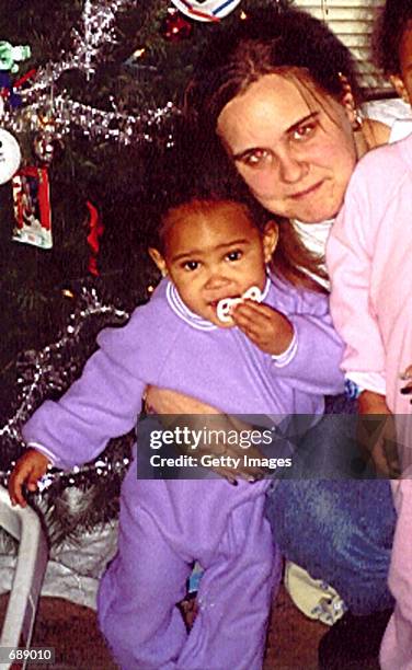 Marcella Anderson of Milwaukee holds her 16-month-old daughter, Jasmine, in a recent family photo. An unidentified woman is suspected of abducting...