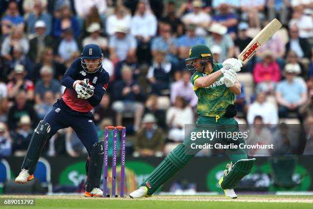 South Africa's AB de Villiers hits out while England wicket keeper Jos Butler looks on during the Royal London ODI match between England and South...