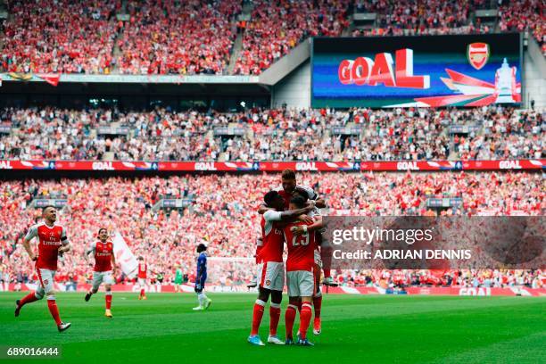 Arsenal's Chilean striker Alexis Sanchez celebrates with teammates after scoring the opening goal of the English FA Cup final football match between...