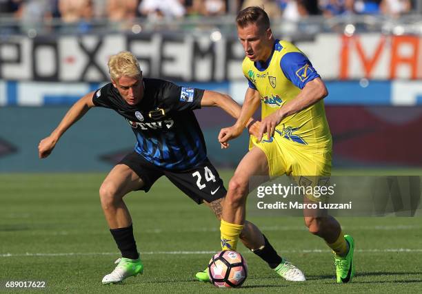 Valter Birsa of AC Chievo Verona competes for the ball with Andrea Conti of Atalanta BC during the Serie A match between Atalanta BC and AC...