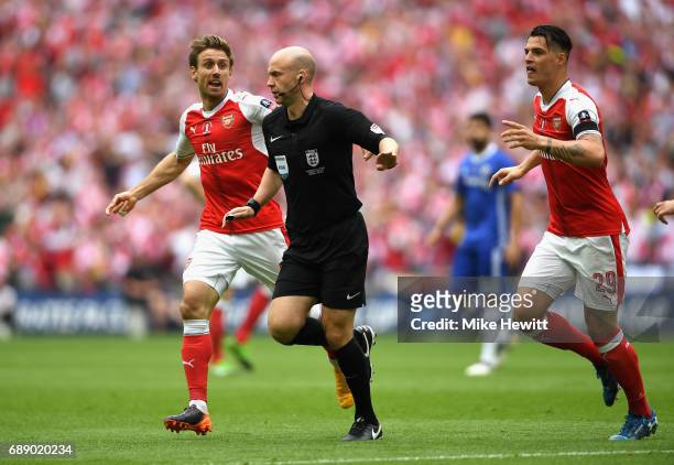 Nacho Monreal of Arsenal and Granit Xhaka of Arsenal appeals to referee Anthony Taylor during the Emirates FA Cup Final between Arsenal and Chelsea...