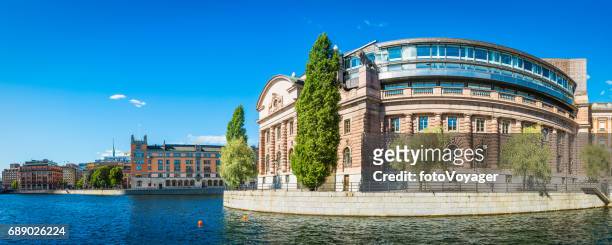 stockholm swedish parliament building riksdagshuset overlooking blue harbour waterfront sweden - government stock pictures, royalty-free photos & images