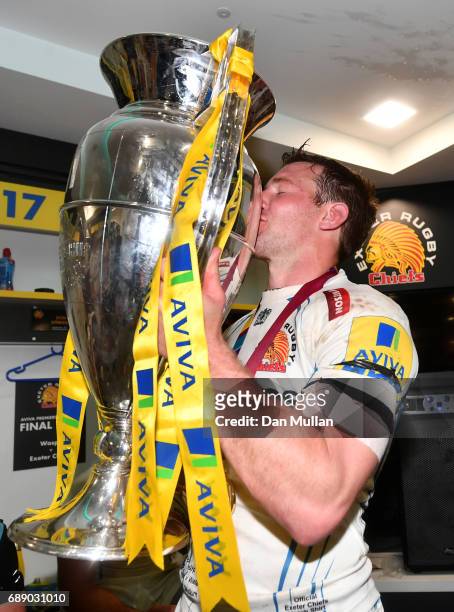 Will Chudley of Exeter Chiefs celebrates with The Aviva Premiership trophy in the changing room after the Aviva Premiership Final between Wasps and...