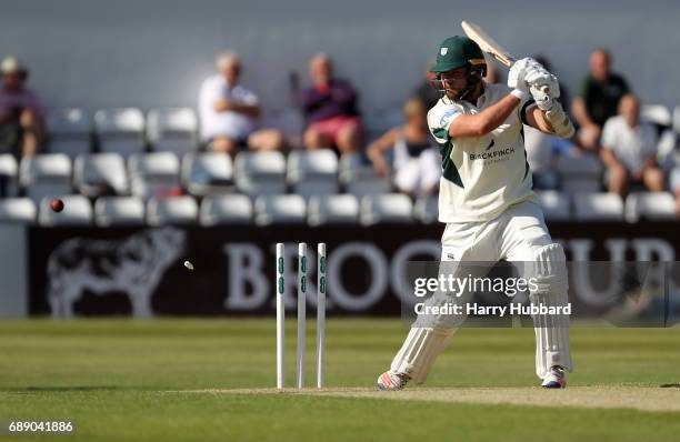 Joe Leach of Worcestershire is bowled by Ben Sanderson of Northamptonshire during the Specsavers County Championship division two match between...