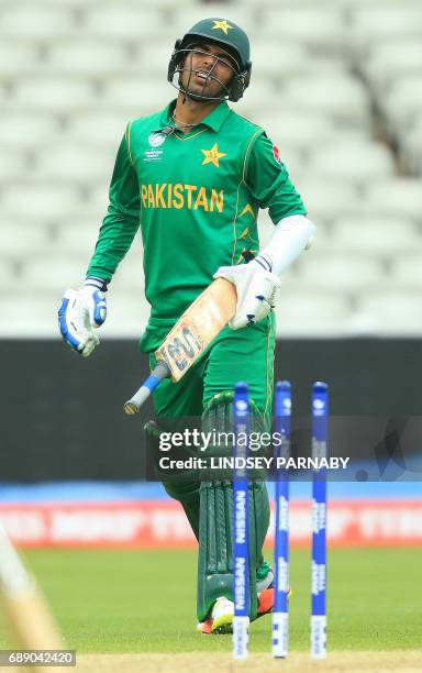 Pakistan batsman Shadab Khan reacts after being run-out by Bangladesh's Mehedi Hasan Miraz during the ICC Champions Trophy Warm-up match between...