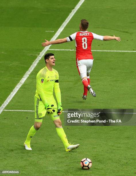 Aaron Ramsey of Arsenal celebrates scoring his sides second goal as Thibaut Courtois of Chelsea is dejected during the Emirates FA Cup Final between...