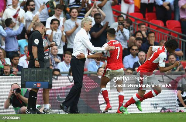 Alexis Sanchez of Arsenal and Arsene Wenger, Manager of Arsenal embrace during the Emirates FA Cup Final between Arsenal and Chelsea at Wembley...