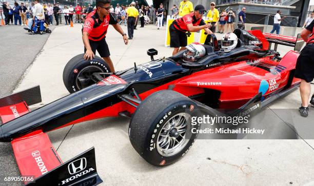 Mario Andretti and Good Morning America correspondent Rob Marciano wait in a two seater IndyCar before their lap at the Indianapolis Motor Speedway...