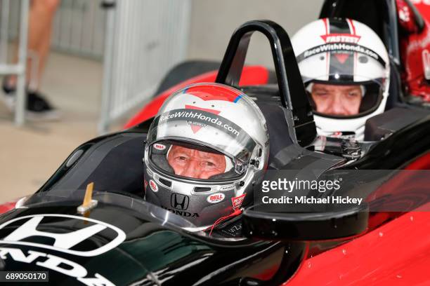 Mario Andretti and actor Paul Giamatti wait in a two seater IndyCar before their lap at the Indianapolis Motor Speedway on May 27, 2017 in...