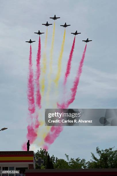 Spanish elite acrobatic flying team 'Patrulla Aguila' perform aerobatics and release trails of red and yellow smoke representing the Spanish flag...