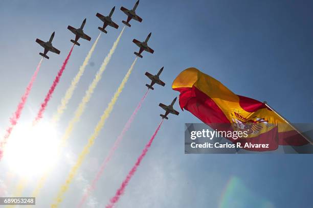 Spanish elite acrobatic flying team 'Patrulla Aguila' perform aerobatics and release trails of red and yellow smoke representing the Spanish flag...