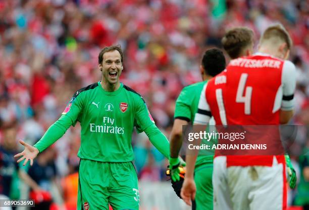 Arsenal's Czech goalkeeper Petr Cech celebrates with his teammates on the pitch after the English FA Cup final football match between Arsenal and...