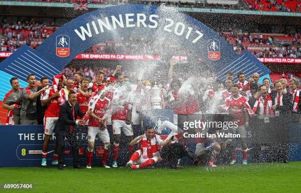 The Arsenal team celebrate with The FA Cup after The Emirates FA Cup Final between Arsenal and Chelsea at Wembley Stadium on May 27, 2017 in London,...