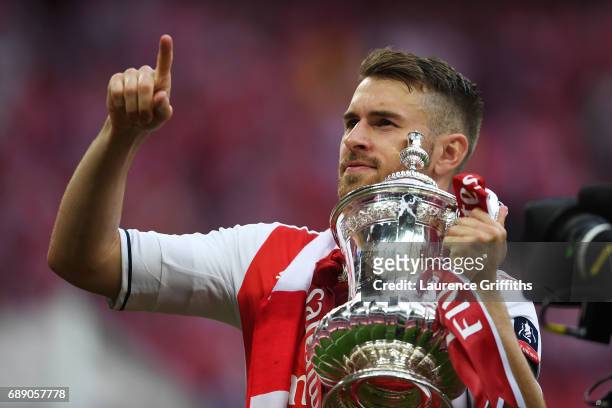 Aaron Ramsey of Arsenal celebrates with the trophy after The Emirates FA Cup Final between Arsenal and Chelsea at Wembley Stadium on May 27, 2017 in...