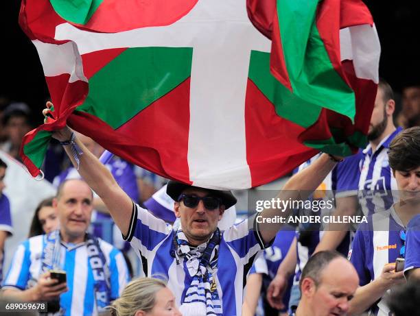 An Alaves' supporter displays a Basque flag before the Spanish Copa del Rey final football match FC Barcelona vs Deportivo Alaves at the Vicente...