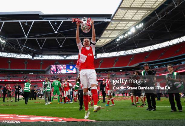 Rob Holding of Arsenal celebrates with the trophy after the Emirates FA Cup Final between Arsenal and Chelsea at Wembley Stadium on May 27, 2017 in...