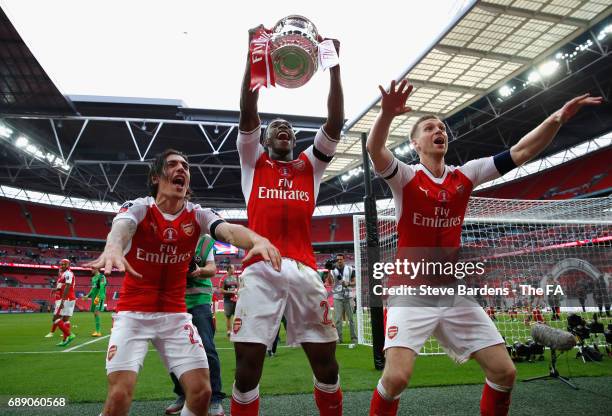 Hector Bellerin of Arsenal, Danny Welbeck of Arsenal and Per Mertesacker of Arsenal celebrate with The FA Cup after the Emirates FA Cup Final between...