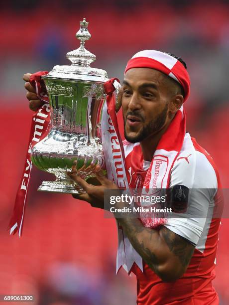 Theo Walcott of Arsenal celebrates with The FA Cup after The Emirates FA Cup Final between Arsenal and Chelsea at Wembley Stadium on May 27, 2017 in...