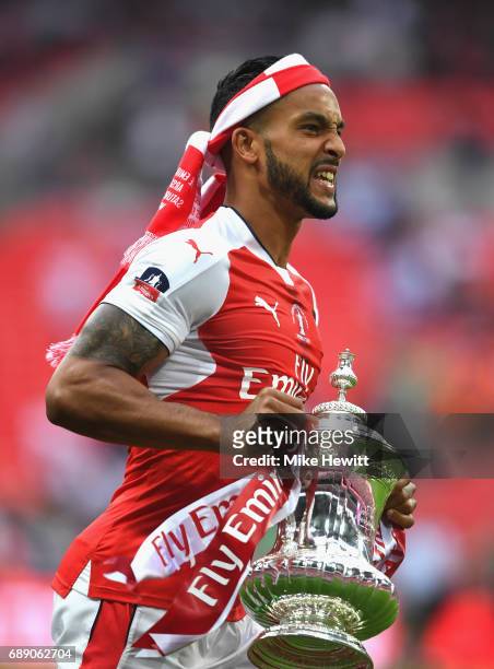 Theo Walcott of Arsenal celebrates with The FA Cup after The Emirates FA Cup Final between Arsenal and Chelsea at Wembley Stadium on May 27, 2017 in...