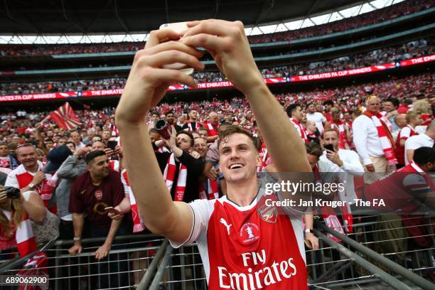 Rob Holding of Arsenal takes a selfie with the Arsenal fans after the Emirates FA Cup Final between Arsenal and Chelsea at Wembley Stadium on May 27,...