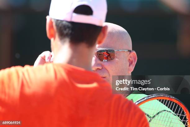 French Open Tennis Tournament - Novak Djokovic of Serbia reflected in the sunglasses of his coach Andre Agassi practicing on Court Philippe-Chatrier...