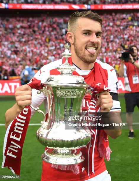 Aaron Ramsey of Arsenal celebrates with the trophy after the Emirates FA Cup Final between Arsenal and Chelsea at Wembley Stadium on May 27, 2017 in...