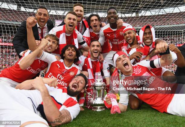 The Arsenal team celerbate with the FA Cup after the Emirates FA Cup Final between Arsenal and Chelsea at Wembley Stadium on May 27, 2017 in London,...