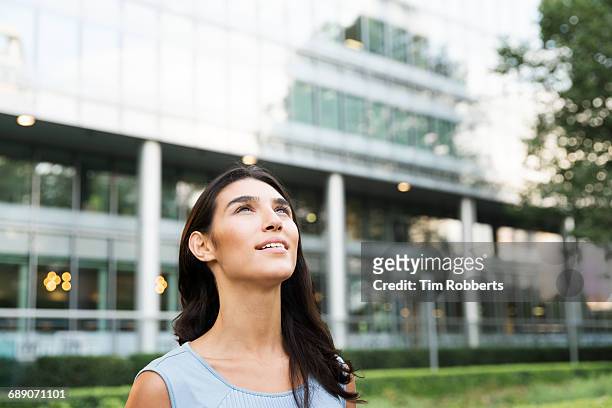 woman looking up - looking up at buildings stock pictures, royalty-free photos & images