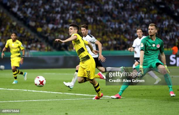 Christian Pulisic of Dortmund is fouled by goalkeeper Lukas Hradecky of Frankfurt during the DFB Cup final match between Eintracht Frankfurt and...