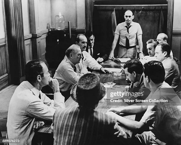 Scene from the film '12 Angry Men' , 1957. Clockwise from left around the table, actors Henry Fonda, Ed Begley, George Voskovec, Robert Webber,...