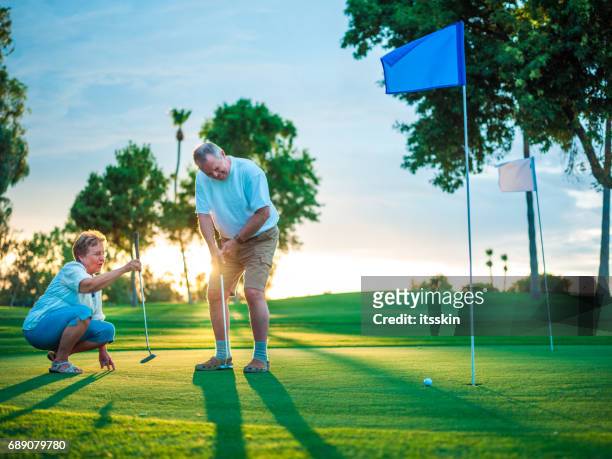 active senior couple playing golf - golf accessories stock pictures, royalty-free photos & images