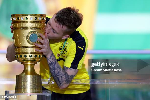 Marco Reus of Dortmund kisses the DFB cup trophy after the DFB Cup Final 2017 between Eintracht Frankfurt and Borussia Dortmund at Olympiastadion on...