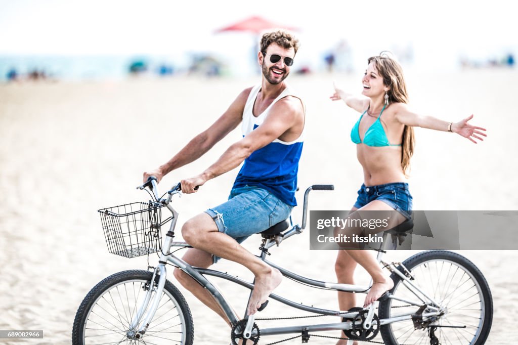 Couple riding tandem bicycle in LA