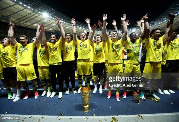 Dortmund players celebrate with the trophy after winning the DFB Cup final match between Eintracht Frankfurt and Borussia Dortmund at Olympiastadion...