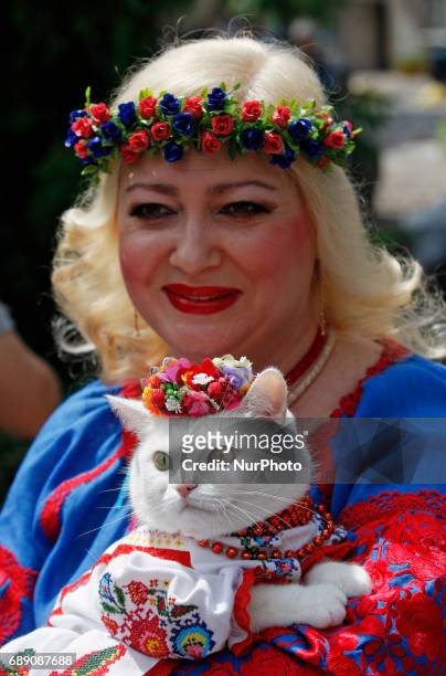 Woman holds her cat dressed in traditional Ukrainian embroidered blouse Vyshyvanka,during the &quot;Vyshyvankas March&quot; in downtown Kiev,...