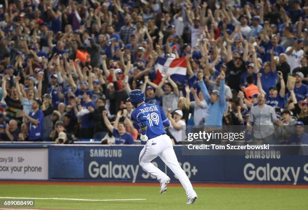 Jose Bautista of the Toronto Blue Jays circles the bases after hitting a three-run home run in the fifth inning during MLB game action against the...