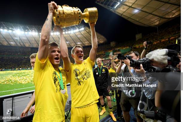 Erik Durm and Matthias Ginter of Dortmund pose with the trophy after winning the DFB Cup Final 2017 between Eintracht Frankfurt and Borussia Dortmund...