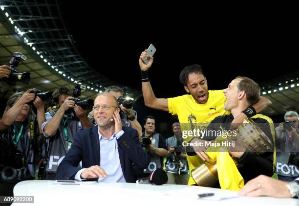 Thomas Tuchel and Pierre-Emerick Aubameyang of Dortmund joke during an interview after winning the DFB Cup final match between Eintracht Frankfurt...