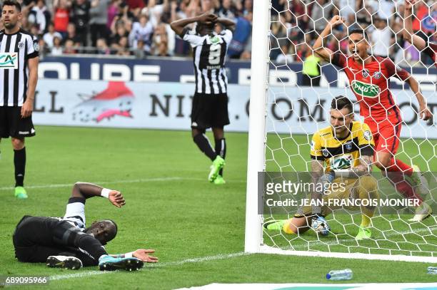 Angers' French defender Issa Cissokho falls as Angers' French goalkeeper Alexandre Letellier and Paris Saint-Germain's Brazilian defender Marquinhos...