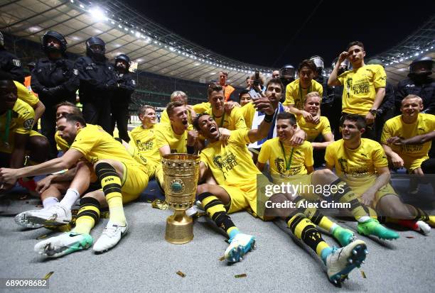 Pierre-Emerick Aubameyang of Dortmund takes a selfie with team mates while celebrating with the trophy after winning the DFB Cup final match between...