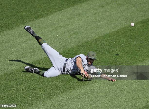 Tyler Collins of the Detroit Tigers dives unsucessfully to try and catch a ball hit by Jose Abreu of the Chicago White Sox in the 8th inning at...